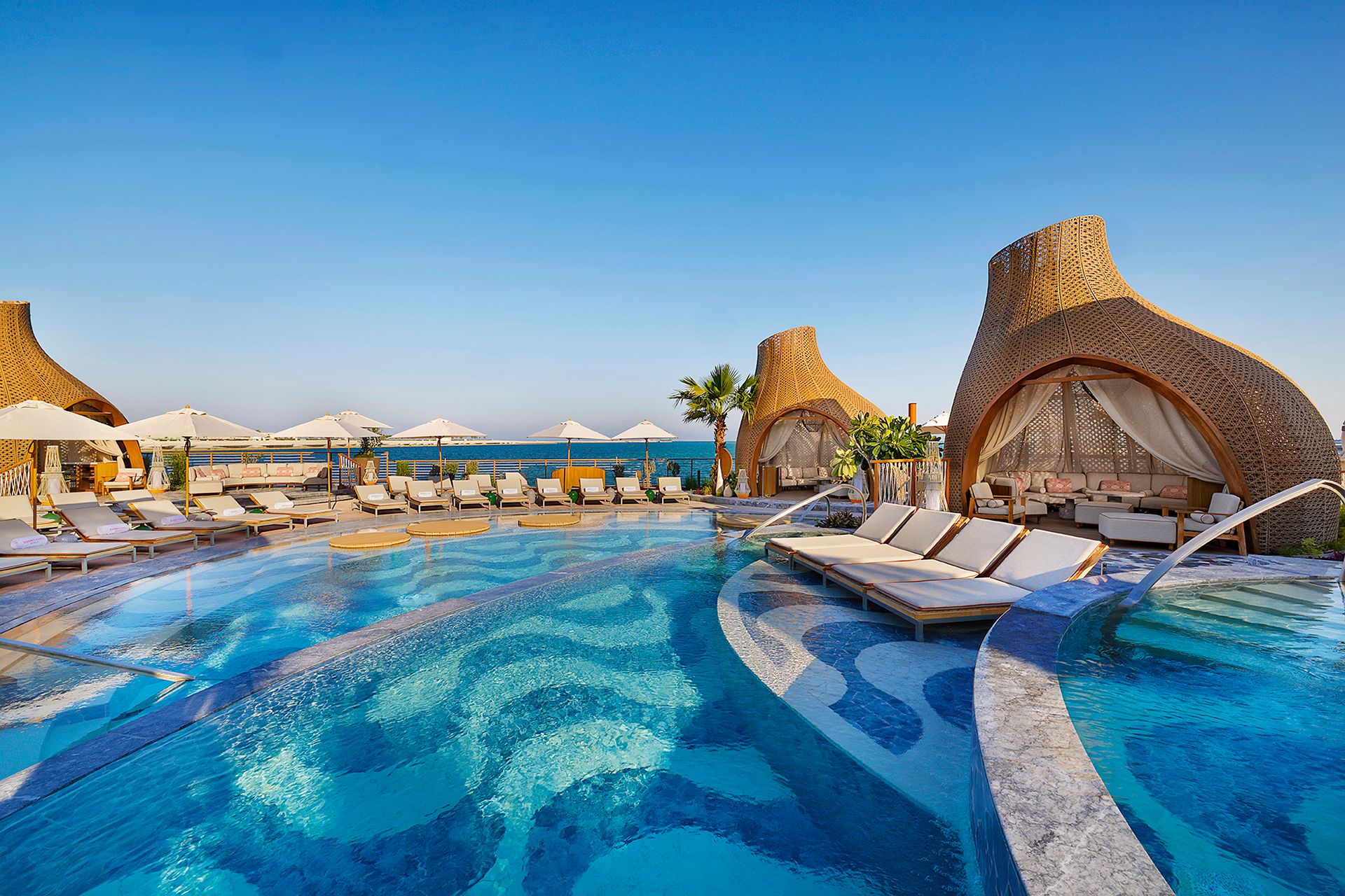 SUSHISAMBA DOHA BEACH CLUB view of the pool with copacabana flooring and cabanas
