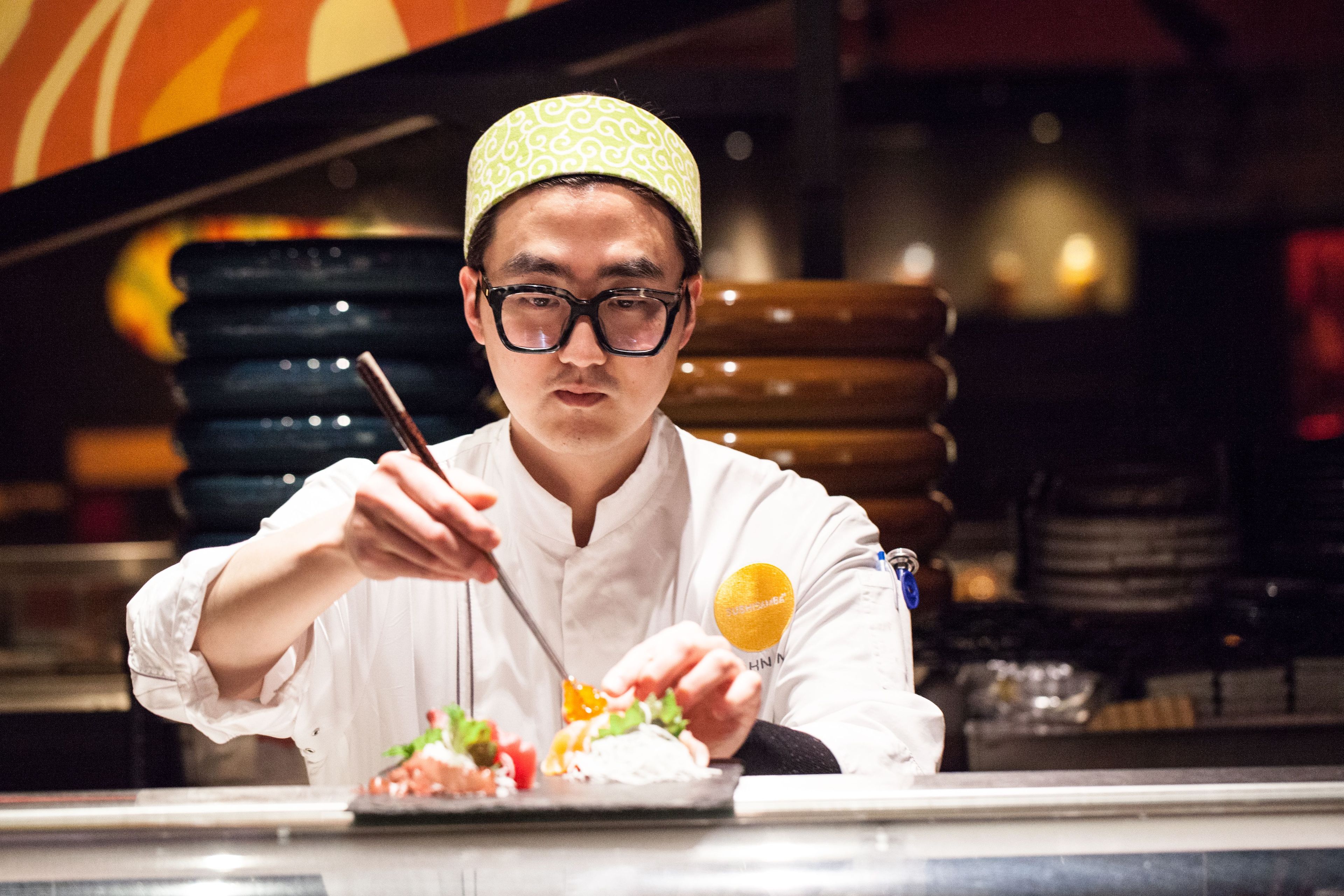 Corporate Chef John Um putting finishing touches on the dish